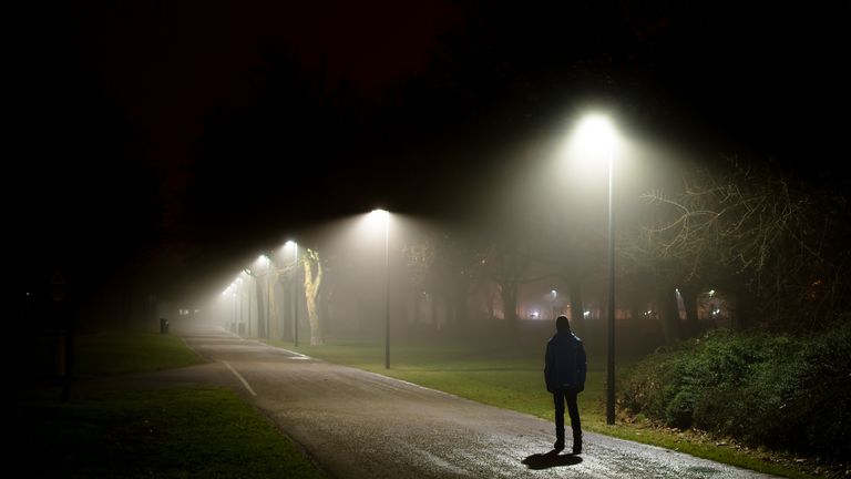 Person walking street at night