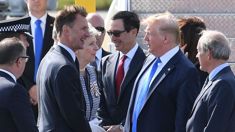 Donald Trump speaks with the Foreign Secretary Jeremy Hunt on the runway