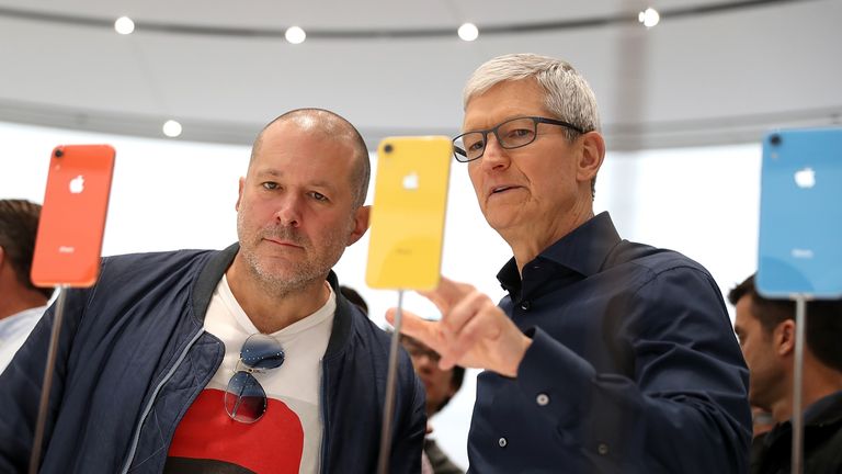 Jony Ive (L) and Apple CEO Tim Cook inspect the new iPhone XR in 2018