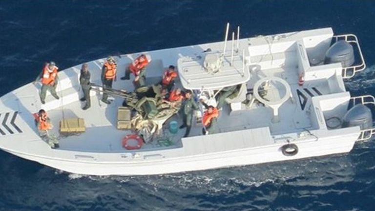 what the Pentagon says are members of the Islamic Revolutionary Guard Corps Navy photographed from a U.S. Navy MH-60R helicopter after removing an unexploded limpet mine from the M/T Kokuka Courageous