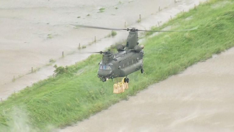 An RAF chinook drops sandbags in Wainfleet, Lincolnshire