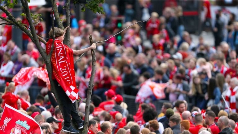 Fans took up any perch to catch a glimpse of the bus