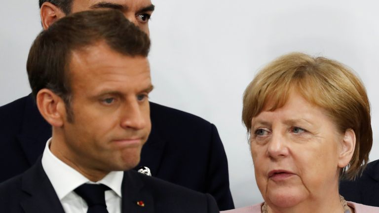 Angela Merkel (R) talks to Emmanuel Macron at the G20 in Osaka