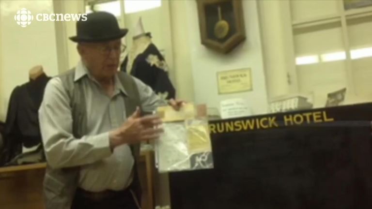 Volunteer Tom Kibblewhite shows the contents of the safe in a clear plastic folder. Pic: CBC