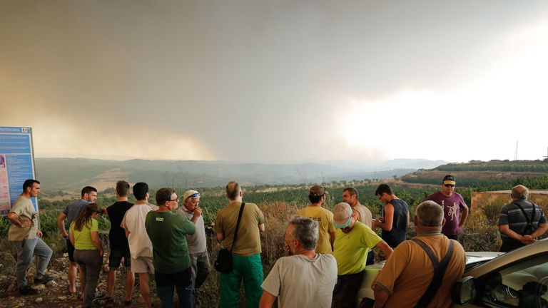 Residents gather to observe a forest fire raging near Maials in the northeastern region of Catalonia on June 27, 2019. - A Spanish forest fire raged out of control amid a European heatwave, devouring land as hundreds of firefighters battled through the night, local authorities said. (Photo by Pau Barrena / AFP) (Photo credit should read PAU BARRENA/AFP/Getty Images)
