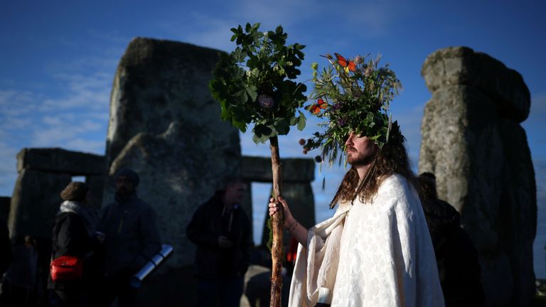 The sun rises as revellers welcome in the Summer Solstice at the Stonehenge stone circle, in Amesbury