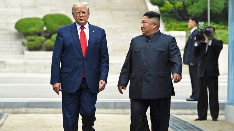 North Korea&#39;s leader Kim Jong Un walks southward with US President Donald Trump, after Trump briefly stepped into the north of the Military Demarcation Line that divides North and South Korea, in the Joint Security Area (JSA) of Panmunjom in the Demilitarized zone (DMZ) on June 30, 2019. (Photo by Brendan Smialowski / AFP)        (Photo credit should read BRENDAN SMIALOWSKI/AFP/Getty Images)