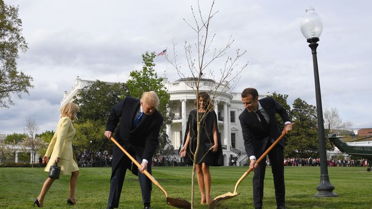US President Donald Trump and First Lady Melania Trump participate in a tree planting ceremony with French President Emmanuel Macron and his wife Brigitte Macron on the South Lawn of the White House in Washington, DC, on April 23, 2018