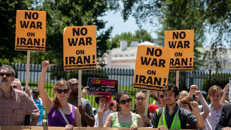 Protesters have gathered outside the White House as tensions heighten between the US and Iran
