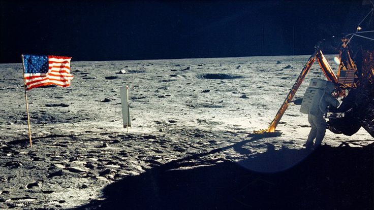 One of the few photographs of Neil Armstrong on the moon shows him working on his space craft on the lunar surface