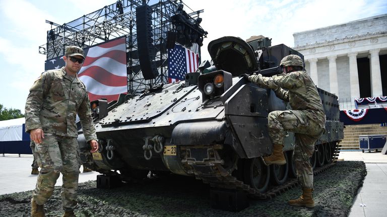 Members of the US military are seen next to a Bradley Fighting Vehicle as preparations are made for the "Salute to America" Fourth of July event with US President Donald Trump at the Lincoln Memorial on the National Mall in Washington, DC, July 3, 2019, which will feature flyovers by the Blue Angels, an airplane used as Air Force One, as well as military demonstrations and a speech by Trump. (Photo by Brendan Smialowski / AFP)        (Photo credit should read BRENDAN SMIALOWSKI/AFP/Getty Images)