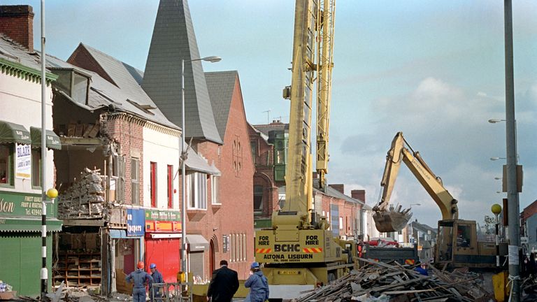 A SCENE OF DEVASTATION IN THE SHANKILL
ROAD, AS THE BOMB SITE IS CLEARED UP.