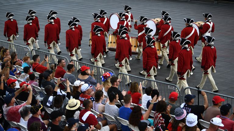 People watch a marching band perform on the National Mall ahead of the "Salute to America" Fourth of July event with US President Donald Trump at the Lincoln Memorial in Washington, DC, July 4, 2019. (Photo by Brendan Smialowski / AFP)        (Photo credit should read BRENDAN SMIALOWSKI/AFP/Getty Images)