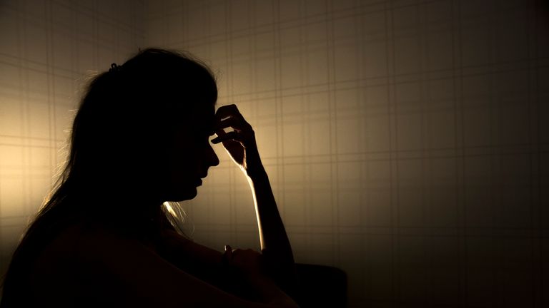 sad woman profile in dark head is put down, stressed young girl touching head and thinkingsad woman profile in dark head is put down, stressed young girl touching head and thinking