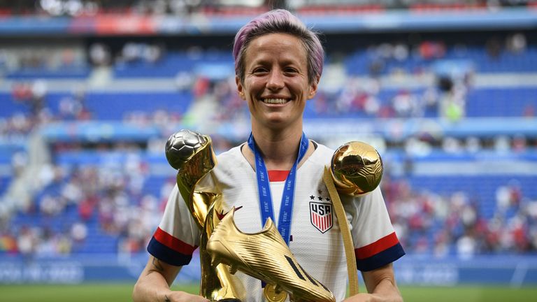 TOPSHOT - United States' forward Megan Rapinoe poses with the trophies after the France 2019 Womens World Cup football final match between USA and the Netherlands, on July 7, 2019, at the Lyon Stadium in Lyon, central-eastern France. (Photo by FRANCK FIFE / AFP)        (Photo credit should read FRANCK FIFE/AFP/Getty Images)