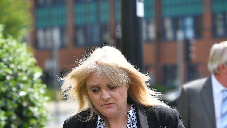 Sherry Bray, 48, leaves Swindon Magistrates' Court where she and Christopher Ashford, 62, were summonsed to appear over an image that allegedly showed the remains of footballer Emiliano Sala at the Holly Tree Lodge mortuary in Bournemouth.