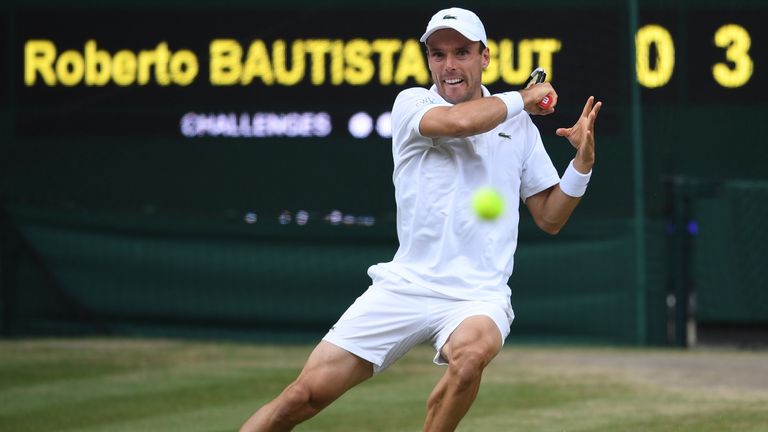 Spain's Roberto Bautista Agut returns against Serbia's Novak Djokovic during their men's singles semi-final match on day 11 of the 2019 Wimbledon Championships at The All England Lawn Tennis Club in Wimbledon, southwest London, on July 12, 2019. (Photo by Ben STANSALL / AFP) / RESTRICTED TO EDITORIAL USE        (Photo credit should read BEN STANSALL/AFP/Getty Images)
