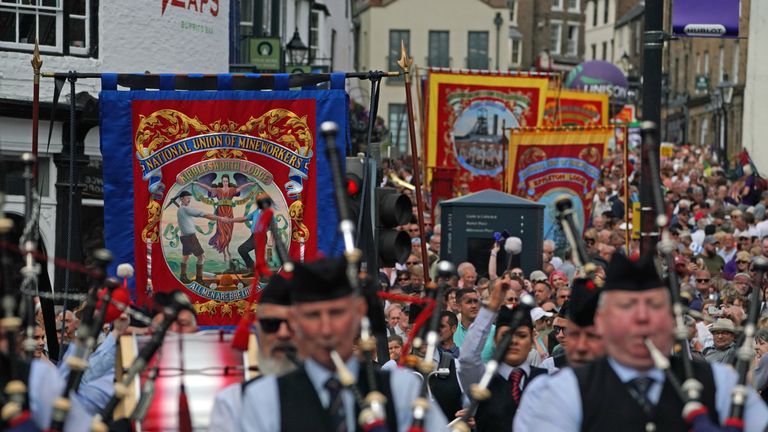 Pipe bands and banners parade through Durham during the Durham Miners' Gala.
