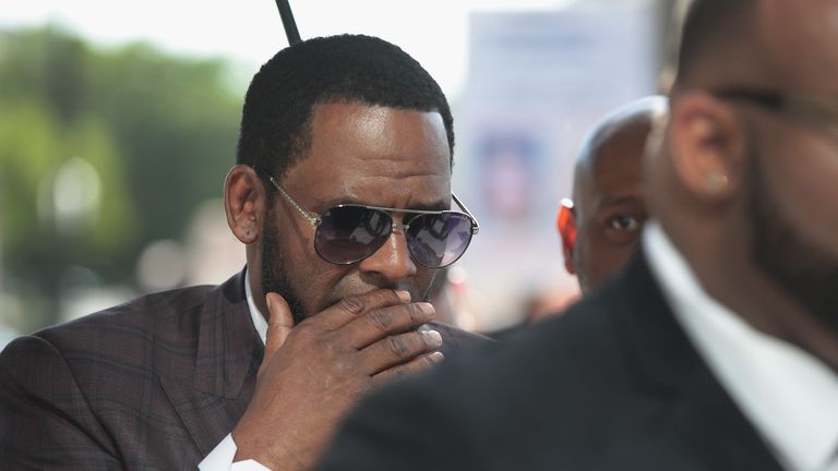 CHICAGO, ILLINOIS - JUNE 26: R&B singer R. Kelly covers his mouth as he speaks to members of his entourage as he arrives at the Leighton Criminal Courts Building for a hearing on June 26, 2019 in Chicago, Illinois.  Kelly is facing several counts of aggravated sexual abuse.  (Photo by Scott Olson/Getty Images)