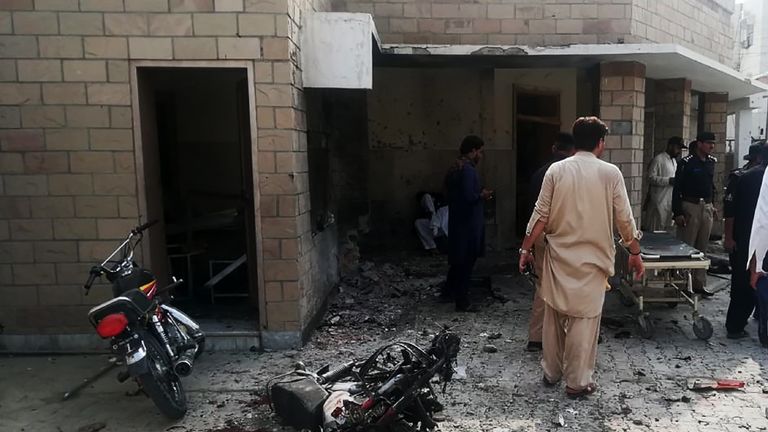 Pakistani security officials examine the site of a suicide bomb attack at the entrance of a hospital in Kotlan Saidan village on the outskirts of the northwestern city of Dera Ismail Khan on July 21, 2019. - A female suicide bomber killed six people -- including two policemen -- in Pakistan's restive northwest on July 21 in an attack claimed by the Taliban, officials said. The attack happened at the entrance of a hospital in Kotlan Saidan village on the outskirts of the northwestern city of Dera Ismail Khan. (Photo by Adil Mughal / AFP)        (Photo credit should read ADIL MUGHAL/AFP/Getty Images)