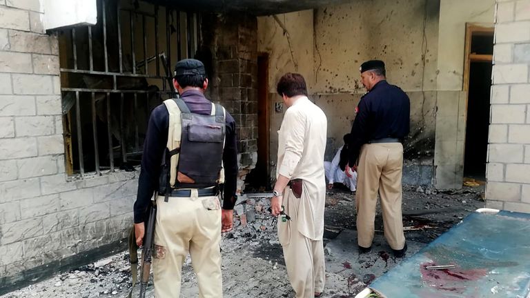 Pakistani security officials examine the site of a suicide bomb attack at the entrance of a hospital in Kotlan Saidan village on the outskirts of the northwestern city of Dera Ismail Khan on July 21, 2019. - A female suicide bomber killed six people -- including two policemen -- in Pakistan's restive northwest on July 21 in an attack claimed by the Taliban, officials said. The attack happened at the entrance of a hospital in Kotlan Saidan village on the outskirts of the northwestern city of Dera Ismail Khan. (Photo by Adil Mughal / AFP)        (Photo credit should read ADIL MUGHAL/AFP/Getty Images)