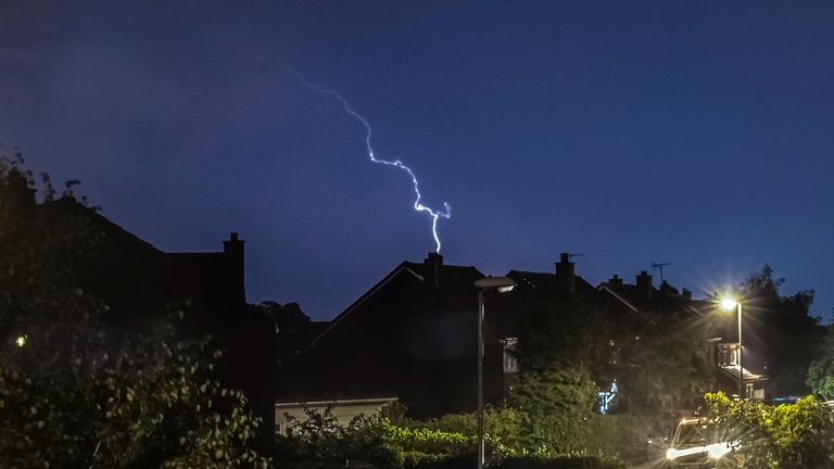 Lightning strikes as a thunder storm passes over houses in Leeds, West Yorkshire. The UK is expected to edge towards its hottest ever July day, with the mercury due to soar above 30C (86F).