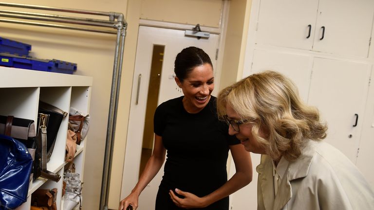 The Duchess of Sussex (centre), reacts as she looks at bags with Lady Juliet Hughes-Hallett, during her visit to Smart Works, in London, on the day that she has become their patron, as well as patron of the National Theatre, the Association of Commonwealth Universities, and the animal welfare charity, Mayhew.