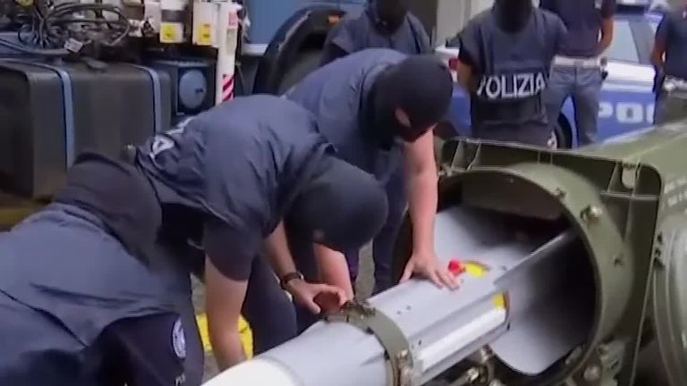 Police in Italy have detained three men, after uncovering automatic weapons, a missile and material featuring Nazi symbols
