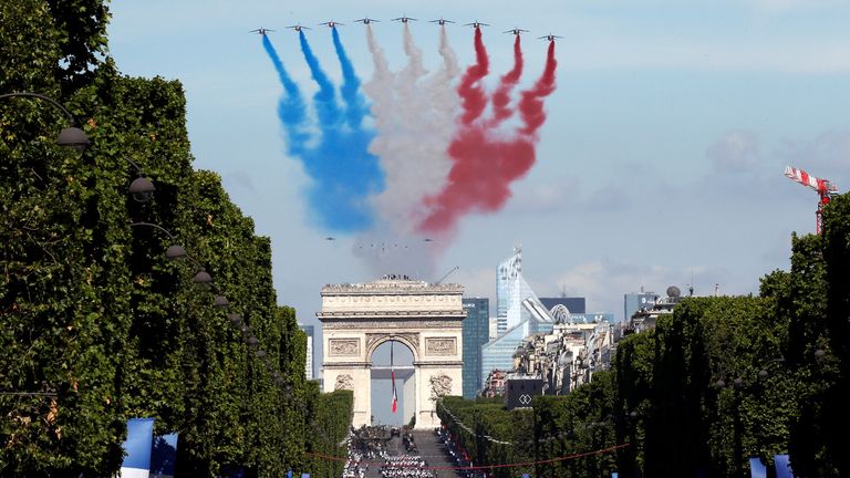 Alpha jets from the French Air Force Patrouille de France fly over the Champs-Elysees avenue during the traditional Bastille Day military parade in Paris, France, July 14, 2017