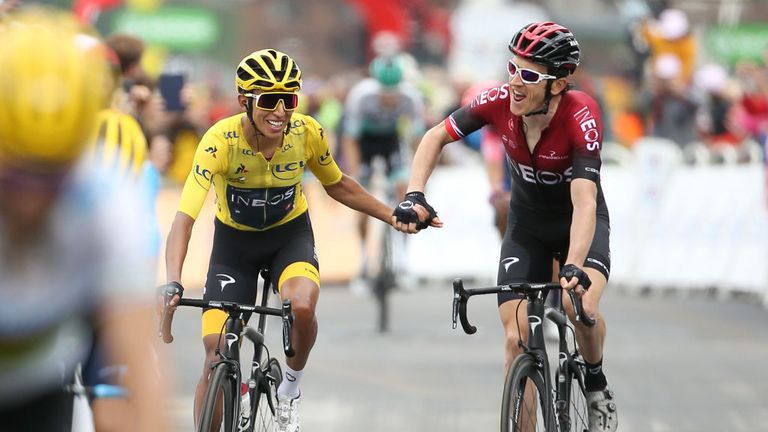 Egan Bernal Gomez of Colombia and Team Ineos is congratulated by teammate and title holder Geraint Thomas