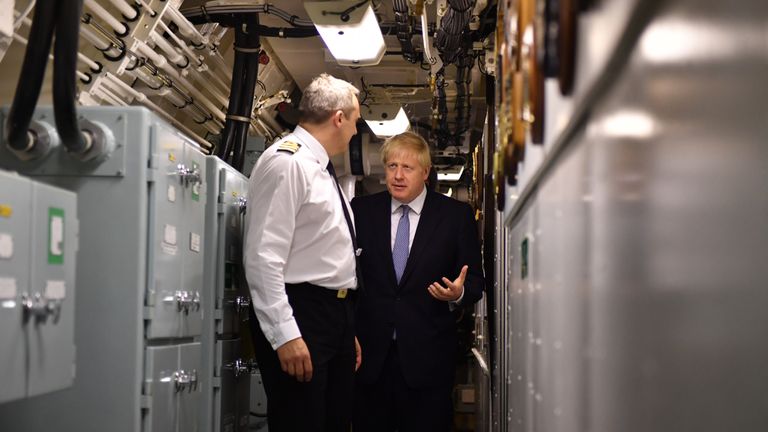 Britain&#39;s Prime Minister Boris Johnson (R) aboard Vanguard-class submarine HMS Vengeance during a visit to Faslane Naval base