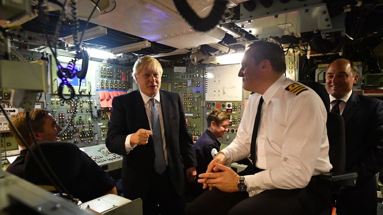 Britain&#39;s Prime Minister Boris Johnson (R) aboard Vanguard-class submarine HMS Vengeance