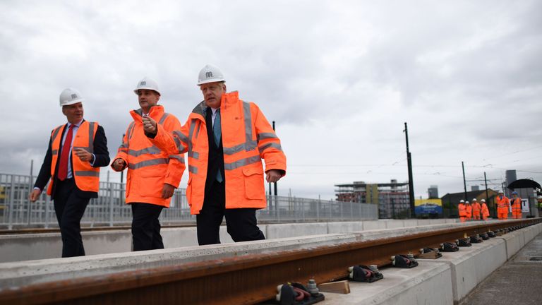 Britain&#39;s Prime Minister Boris Johnson (R) walks with CEO of Transport for the North, Barry White (L) and Britain&#39;s Northern Powerhouse Minister, Jake Berry as he leaves the site of an under-construction tramline in Stretford, greater Manchester, northwest England on July 27, 2019, prior to giving a speech focusing on domestic priorities. (Photo by Ben STANSALL / POOL / AFP) / The erroneous mention[s] appearing in the metadata of this photo by Ben STANSALL has been modified in AFP systems in the