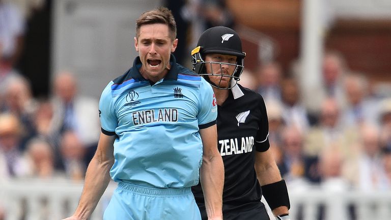 England's Chris Woakes celebrates taking the wicket of Martin Guptill