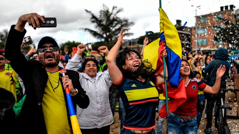 Colombians celebrate as they watch the Tour de France in Zipaquira, Cundinamarca, Colombia