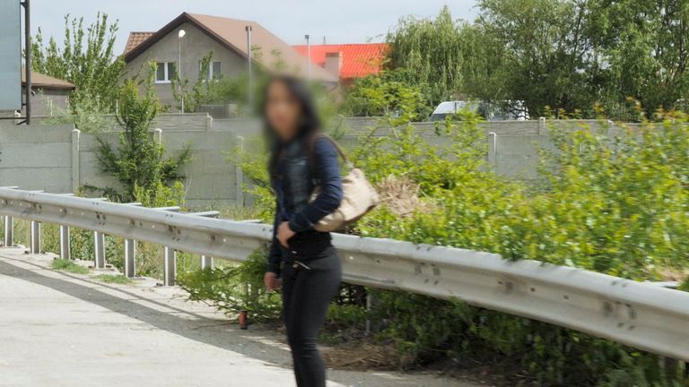 Generic shot of a young female sex worker next to the road in Craiova (note: faces intentionally blurred to protect identities)