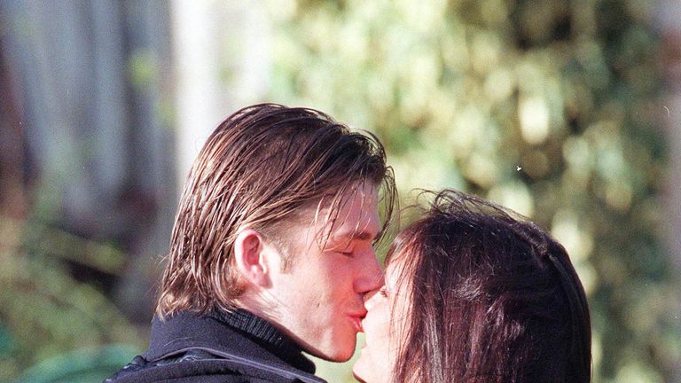 Footballer David Beckham and fiance singer from the "Spice Girls" Victoria Adams pose for photographers outside their hotel after the announcement of their engagement on January 25, 1998 in Chester, United Kingdom