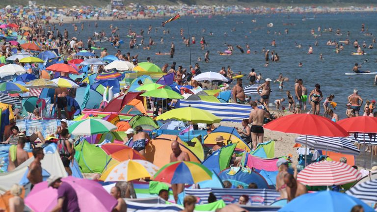 People crowd the beach at Zinnowitz on the island of Usedom in the Baltic Sea, northern Germany where temperatures reached 34 degrees Celsius