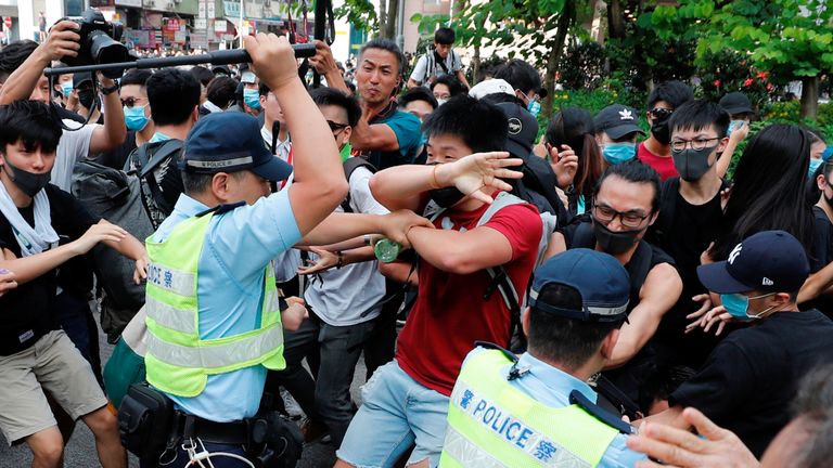 Police swing their batons at pro-democracy protesters at Sheung Shui