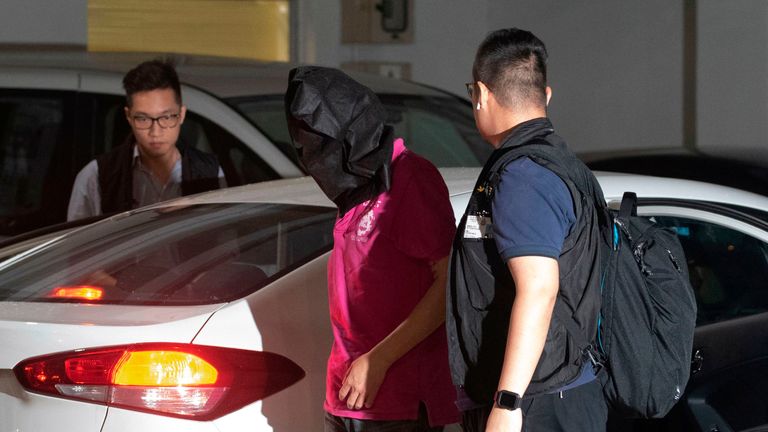 A suspect is taken away by police after his arrest