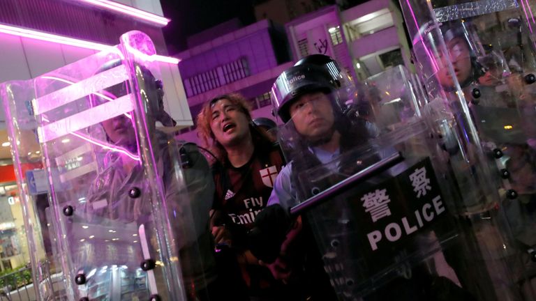 Riot police detained a pro-democracy protester in Hong Kong