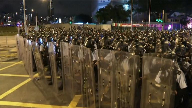 Riot police take up positions after protesters storm a government building in Hong Kong