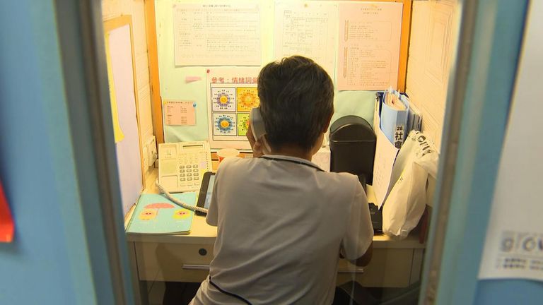 A charity worker mans a telephone help line to help people wanting to take their own lives. 