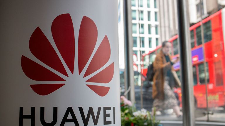 A pedestrian walks past a Huawei product stand at an EE telecommunications shop in central London on April 29, 2019. - British Foreign Secretary Jeremy Hunt has urged caution over the role of China's Huawei in the UK, saying the government should think carefully before opening its doors to the technology giant to develop next-generation 5G mobile networks. His comments come after Prime Minister Theresa May conditionally allowed China's Huawei to build the UK 5G network, information that was leak