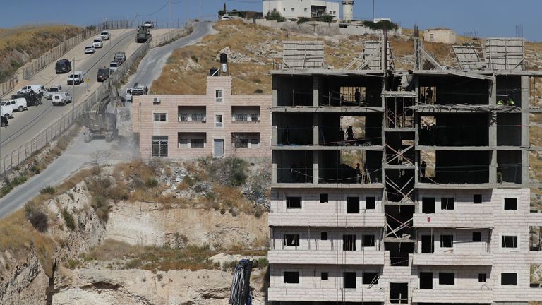 Israeli security forces demolishing a building which was earlier evacuated of its residents as they demolish the Palestinian buildings, some still under construction, which have been issued notices to be demolished in the Wadi al-Hummus area adjacent to the Palestinian village of Sur Baher