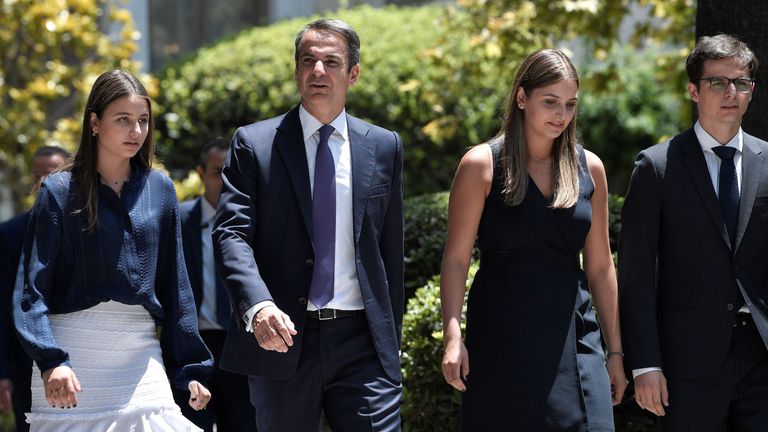 Leader of New Democracy conservative party and winner of Greek general election Kyriakos Mitsotakis leaves the presidental palace flanked by his children after being sworn-in as a prime minister of Greece on July 8, 2019. - Greece&#39;s new prime minister, Kyriakos Mitsotakis, formally takes up the reins on July 8, a day after an election victory that puts him in charge of the EU&#39;s most indebted member with promises to end a decade of economic crisis. (Photo by Louisa GOULIAMAKI / AFP) (Photo credit