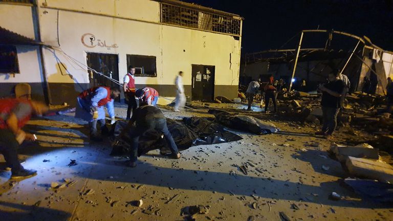 Emergency workers remove the bodies of some of te dead from the building