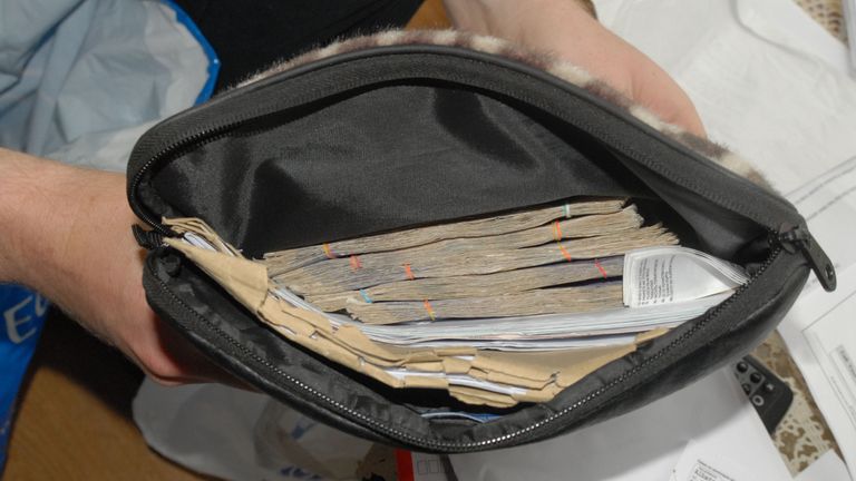 Some of £13,000 in cash that was seized from an address linked to two of the gang members