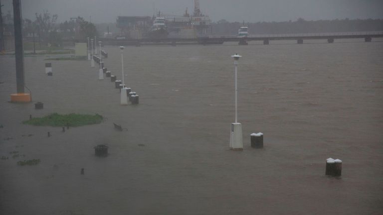 Benches and walkways are flooded by water along the Berwick River in Morgan City, Louisiana ahead of Tropical Storm Barry Saturday, July 13,2019