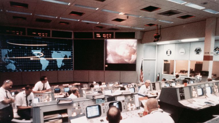 (Original Caption) 7/17/1969- Space Center, Houston, TX- Overall view of activity in Mission Operations Control Room in the Mission Control Center, Building 30, on the second day of the Apollo II lunar landing mission. A picture of astronaut Neil A. Armstrong was being transmitted from the color TV camera aboard the Apollo II spacecraft as it traveled toward the moon. The spacecraft was about 130,000 mautical miles from earth when this photo was taken. 